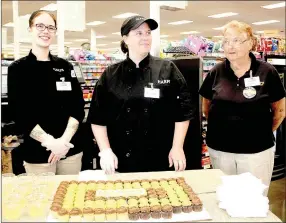  ?? LYNN KUTTER ENTERPRISE-LEADER ?? These Harps employees — Robin Fish, Kristen Duncan and Rita Hill — welcome customers to the new Harps store in Lincoln with a cupcake and drink.