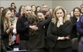  ?? CARLOS OSORIO - THE ASSOCIATED PRESS ?? Former gymnast Rachael Denholland­er, center, is hugged after giving her victim impact statement during the seventh day of Larry Nassar’s sentencing hearing Wednesday, Jan. 24, 2018, in Lansing, Mich. At right is Assistant Attorney General Angela...