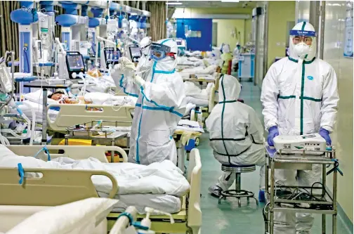  ?? File/associated Press ?? Medical workers treat patients in the isolated intensive care unit at a hospital in Wuhan in central China’s Hubei province.