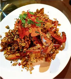  ?? — Photos: BRIAN MARTIN/The Star ?? Je Ngor’s stirfried shredded morning glory (far left) and stir-fried crab with black pepper are Michelin Guide recommende­d dishes.