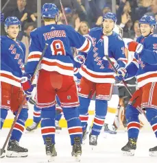  ?? MARY ALTAFFER/AP ?? Rangers defenseman Jacob Trouba celebrates with his teammates after scoring a goal during the first period against the Flyers on Wednesday at Madison Square Garden in New York.