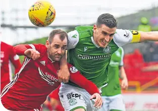  ??  ?? Aberdeen’s Niall Mcginn and Hibernian’s Paul Hanlon battle for the ball