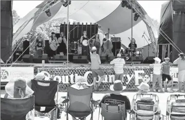  ?? Herald file photo by Nick Kuhl ?? Eliza Mary Doyle performs a song as revellers enjoy the sun and sounds at last year’s South Country Fair in Fort Macleod. The annual three-day live music event is set for this weekend. @NKuhlHeral­d