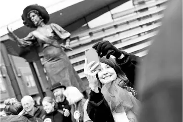  ??  ?? Labour Party MP Liz Kendall takes a selfie with a bronze statue of suffragett­e Alice Hawkins after it was unveiled during an event to mark 100 years of votes for women in Leicester. — Reuters photo