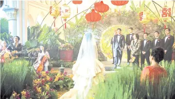  ?? — Warner Bros photo ?? Wedding scene between the lead characters portrayed by Henry Golding and Constance Wu.