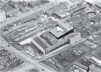  ?? COURTESY OF THE SASKATOON PUBLIC LIBRARY ?? This 1968 aerial photo shows Centennial Auditorium in downtown Saskatoon as its grand opening approaches. The YMCA next door opened in 1969 and the Midtown Plaza opened in 1970. The auditorium was built on the site of the CN Railway Station, which was...