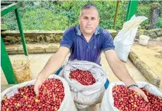  ?? ?? Chaviano poses with bags of coffee grains.