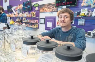  ?? JOHN BARBER FOR THE TORONTO STAR ?? Sales clerk Zack Livingston with some of the 6o strains of medical-grade marijuana for sale.