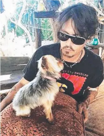  ??  ?? Johnny Depp with one of two dogs he brought to the Gold Coast with Amber Heard.