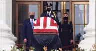  ?? Alex Wong / Getty Images ?? President Donald Trump and first lady Melania Trump pay their respects to Associate Justice Ruth Bader Ginsburg's flag-draped casket at the Supreme Court on Thursday.