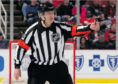  ?? GREGORY SHAMUS/Getty Images ?? Evgeny Romasko, the first Russian referee to officiate an NHL game, makes a call Monday during a game in Detroit.