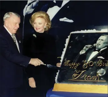  ?? PICTURE: REUTERS/AFRICAN NEWS AGENCY (ANA) ?? Music legend Frank Sinatra, joined by his fourth wife Barbara, cuts an oversize 80th birthday cake during a ceremony in his honour in New York City, US on November 30, 1995.