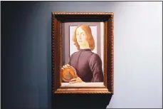  ??  ?? Sandro Botticelli’s 15th-century painting called ‘Young Man Holding a Roundel’ is displayed at Sotheby’s on Sept 23, in New York. The painting will go on auction next year and art watchers will be seeing if it fetches more than its eye
watering $80 million estimate, despite the pandemic. (AP)