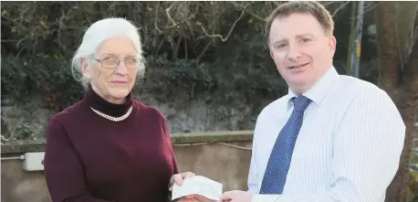  ??  ?? Claire Leonard accepts a cheque on behalf of the Louth/Meath branch of Down Syndrome Ireland from Tony Mallon. The funds were raised at the recent ‘night at the opera’ in Dunleer.