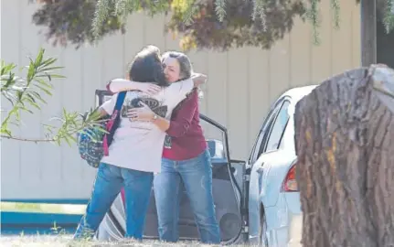  ?? Rich Pedroncell­i, The Associated Press ?? Two women on Tuesday embrace outside Rancho Tehama Elementary School in Rancho Tehama Reserve, Calif., where a gunman opened fire in the northern California area.