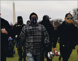  ?? CAROLYN KASTER — THE ASSOCIATED PRESS ?? Proud Boys members Joseph Biggs, left, and Ethan Nordean, right with megaphone, walk toward the U.S. Capitol in support of President Donald Trump on Jan. 6.