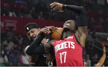  ?? MARK J. TERRILL — THE ASSOCIATED PRESS ?? CLIPPERS
The Rockets’ Dennis Schroder, right, is fouled by Marcus Morris Sr. of the Clippers during Thursday night’s game.