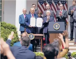  ?? EVANVUCCI/AP ?? President Donald Trump poses after signing the Paycheck Protection Program Flexibilit­y Act on June 5 in the Rose Garden at the White House.