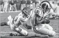  ?? AP PHOTO ?? Los Angeles Rams tight end Gerald Everett scores a touchdown after catching a pass ahead of Kansas City Chiefs defensive back Daniel Sorensen Monday in Los Angeles.