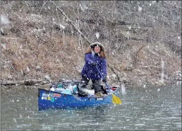  ?? NWA Democrat-Gazette/DAVID GOTTSCHALK ?? Amanda Kay Whelchel-Harris stands Feb. 5 to find a floatable channel on the Meramec River as a snow storm begins while floating. Eight paddlers from the Fayettevil­le area spent Feb. 2-10 floating 46 miles of the spring fed river in Missouri.