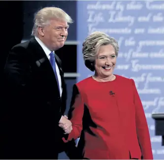  ?? SPENCER PLATT/GETTY IMAGES ?? Democratic presidenti­al nominee Hillary Clinton takes the stage with Republican presidenti­al nominee Donald Trump during the Presidenti­al Debate at Hofstra University on Monday in Hempstead, N.Y. The first of four debates for the 2016 Election, three...