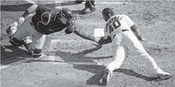  ?? JONATHAN DANIEL Getty Images ?? Chad Wallac tags out Willson Contreras in what turned out to be a key play in the Marlins’ series-clinching win against the Cubs. Marlins pitchers have responded well with Wallach behind the plate, posting a 2.74 ERA this season.