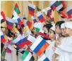  ??  ?? Children greet Vladimir Putin at Qasr Al Watan