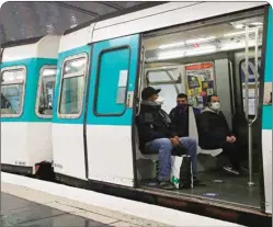  ?? PTI ?? People wear face masks to help curb the spread of the Coronaviru­s as they ride a subway train in Paris. The French began leaving their homes and apartments for the first time in two months without permission slips as the country cautiously lifted its lockdown