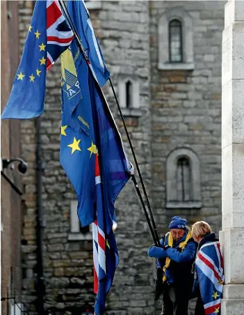  ?? AP ?? Pro-European demonstrat­ors raise flags to protest, outside parliament in London as the debate over Brexit drags on.