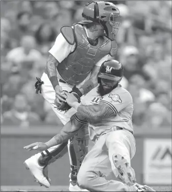  ?? AP/TOM GANNAM ?? Milwaukee’s Eric Thames (right) is tagged out at home by Cardinals catcher Yadier Molina on Thursday in St. Louis.