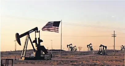  ?? JIM THOMPSON/JOURNAL ?? Oil rigs work in Maljamar in eastern New Mexico. The state’s booming oil and gas industry generated a record $2.2 billion in government income in fiscal year 2018.