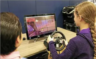  ?? SUBMITTED PHOTO ?? Kutztown High School students learn about the dangers of driving DUI and distracted using a simulator at an educationa­l event hosted by the high school’s SADD program.