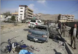  ?? THE ASSOCIATED PRESS ?? Afghan security personnel gather at the site of a car bomb attack in Kabul, Afghanista­n, in November. The U.S. and Afghan officials hope to sign a peace deal Saturday.