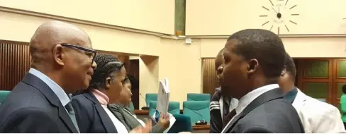  ?? ?? ▲ The AG Timothy Simelane conversing with Ministry of Health PS Khanyakwez­we Mabuza after the sitting was adjourned.