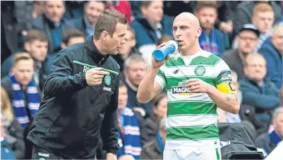  ??  ?? Ronny Deila and Scott Brown put their heads together in last season’s Old Firm semi-final to no avail.