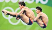  ??  ?? The nation’s darling: Daley in action at the Rio Olympics in 2016. Below, with his late father, Robert, who baby Robbie is named after