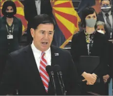  ?? PHOTO BY HOWARD FISCHER/CAPITOL MEDIA SERVICES ?? GOV. DOUG DUCEY SAID THURSDAY IT’S UP to Congress and not the state to deal with the fact that unemployme­nt assistance is on the verge of being cut by more than half. With him is state schools chief Kathy Hoffman.