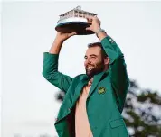  ?? Matt Slocum/Associated Press ?? Scottie Scheffler holds the trophy after winning the Masters golf tournament in Augusta, Ga., Sunday.