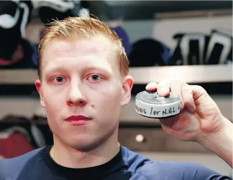  ?? JEFF VINNICK/NHLI VIA GETTY IMAGES ?? Canucks call-up Ronalds Kenins displays the puck after scoring his first NHL goal against the Minnesota Wild on Sunday at Rogers Arena. In his second NHL game, the 23-year-old Latvian fired a shot through the legs of Wild goalie Devan Dubnyk.