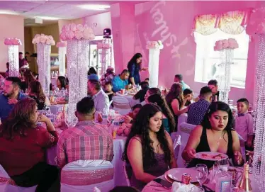  ?? Amanda Andrade-Rhoades / Washington Post ?? Friends and family members gather during Ashley Servin’s quinceañer­a celebratio­n on Sept. 4 at Harmony Hall in Hamilton, Va. Many families have had to delay the tradition because of the pandemic.