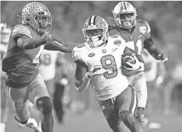  ?? MATTHEW EMMONS/USA TODAY SPORTS ?? Clemson running back Travis Etienne (9) scores the winning TD touchdown against Ohio State.