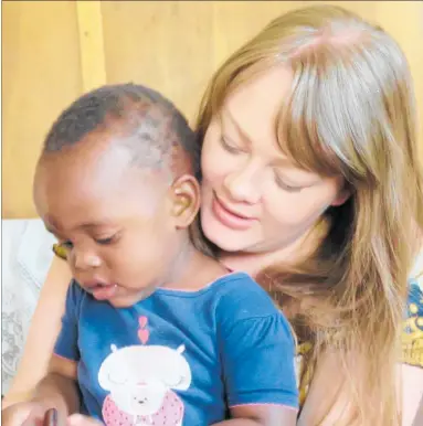  ??  ?? Jackie Scott with baby Jackie whom she rescued from under a bush aged one month, now 2 years old and a very healthy toddler.