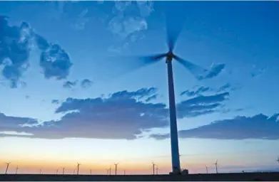  ?? XINHUA ?? A wind turbine system generates energy in the Xinjiang Uygur autonomous region. China has made a huge investment in wind and solar power to promote green