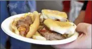  ??  ?? In this file photo, hot dog and sliders are served hot off the grill from Jack’s Drive In.