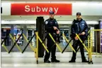  ?? AP PHOTO BY ANDRES KUDACKI ?? Police stand guard inside the Port Authority Bus Terminal following an explosion near Times Square on Monday in New York.