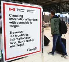  ?? (Chris Wattie/Reuters) ?? A SIGN warns travelers about crossing internatio­nal borders with cannabis at the Ottawa Internatio­nal Airport.