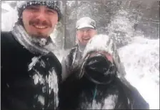  ??  ?? Adam, Mick and Shannon hiking during the blizzard.