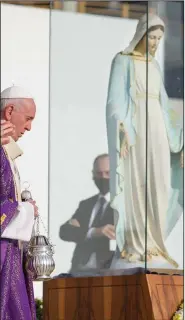  ?? (AP/Andrew Medichini) ?? Pope Francis blesses a statue of the Virgin Mary as he celebrates Mass on Sunday at Franso Hariri Stadium in Irbil, Iraq. The statue, which was vandalized by the Islamic State militant group in the Christian village of Karemlash, is being restored after it was beheaded and its hands were chopped off.