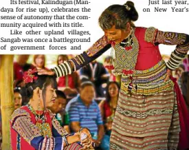  ??  ?? Mandaya leader Christine Banugan (seated) is blessed by Sangab’s chief priestess.