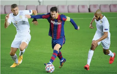  ?? File/AFP ?? Ferencvaro­s’ midfielder­s Eldar Civic and Aissa Laidouni challenge Barcelona’s forward Lionel Messi during a recent football match.